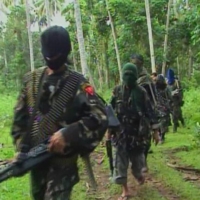 Abu Sayyaf rebels are seen in the Philippines in this video grab from February 2009.   | REUTERS