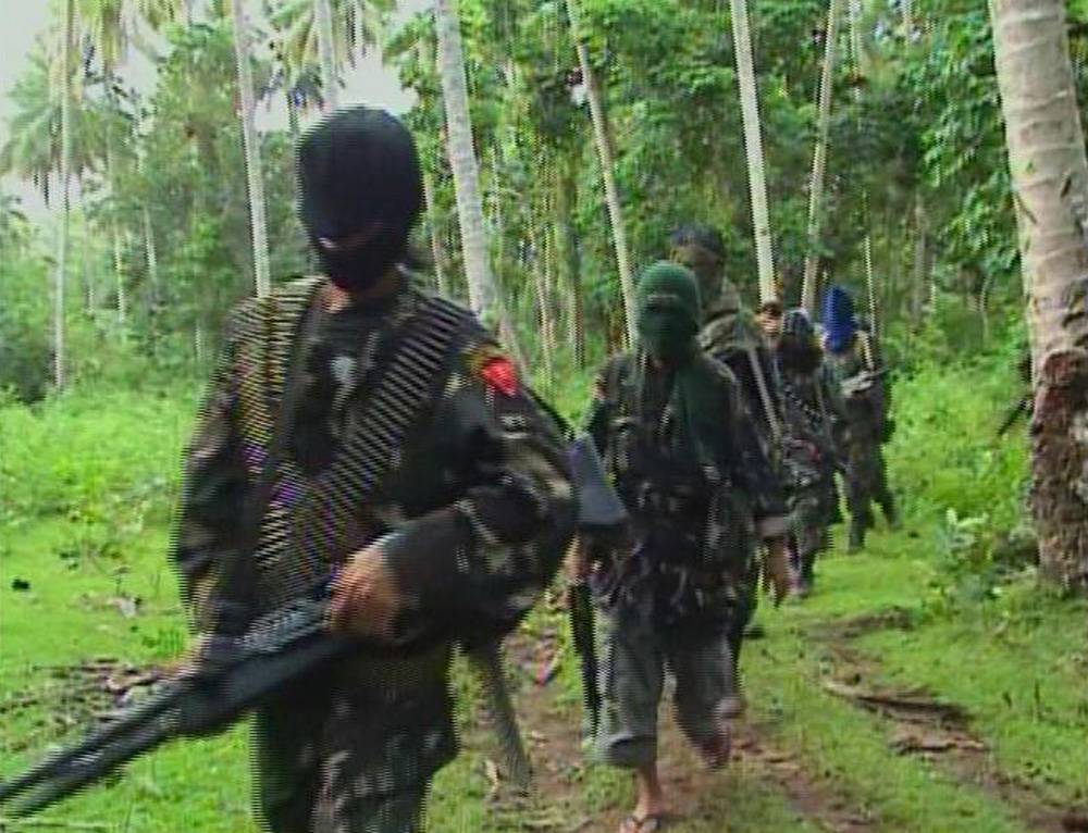 Abu Sayyaf rebels are seen in the Philippines in this video grab from February 2009.   | REUTERS