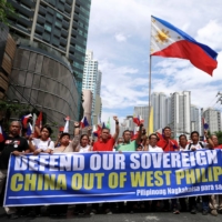 Filipino activists and opposition leaders march to protest against the presence of Chinese vessels in South China Sea at the Chinese Embassy in Makati City, Philippines, in April 2019.  | REUTERS