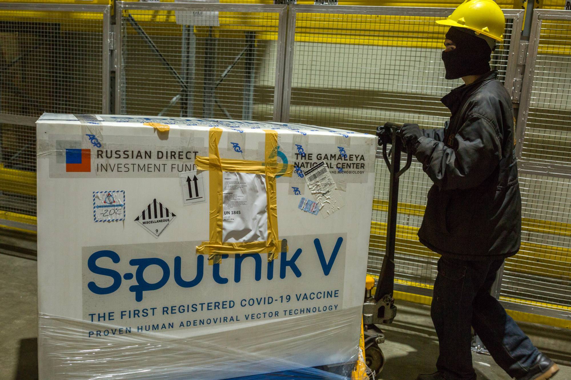 A worker pushes a crate of the Sputnik V COVID-19 vaccine at a cold storage facility in Karachi on Friday. | BLOOMBERG