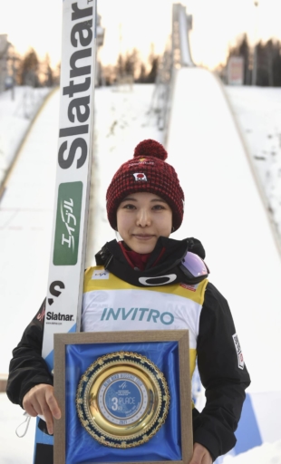 Sara Takanashi poses for photos after finishing third in a World Cup event in Nizhny Tagil, Russia, on Sunday. Takanashi tied the career record with her 108th podium finish.  | KYODO
