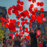 Residents release balloons on Monday bearing messages calling for international help following the coup in Myanmar, in Yangon\'s Hlaing township.  | FACEBOOK / VIA AFP-JIJI 