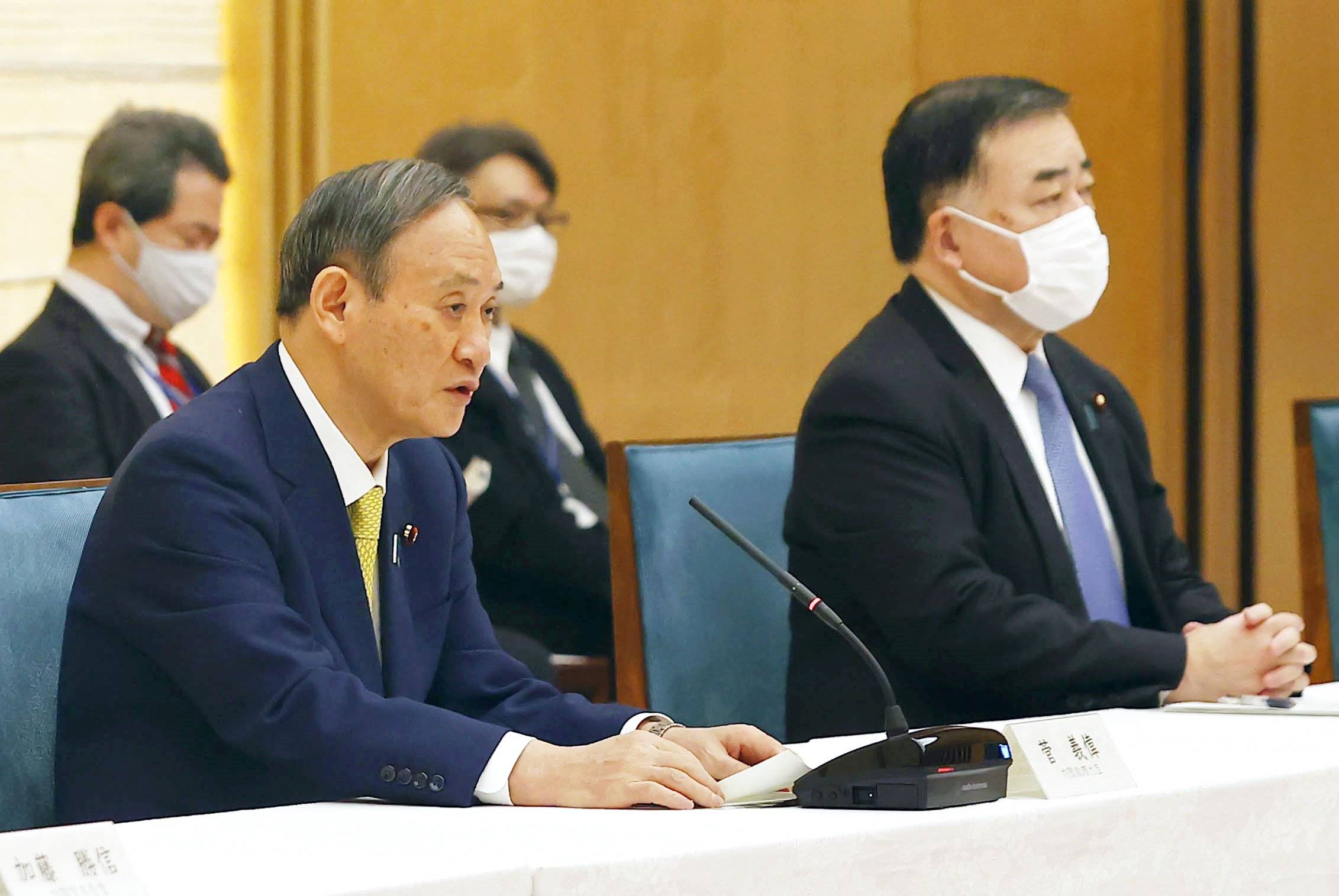 Prime Minister Yoshihide Suga speaks at a meeting of Cabinet ministers on additional spending for COVID-19 measures on Tuesday. | KYODO
