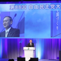 Prime Minister and ruling Liberal Democratic Party leader Yoshihide Suga speaks during the annual party convention in Tokyo on Sunday. | POOL / VIA AFP-JIJI