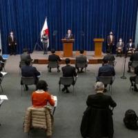 Members of the media attend a news conference held by Prime Minister Yoshihide Suga in Tokyo on March 5. | POOL /VIA REUTERS