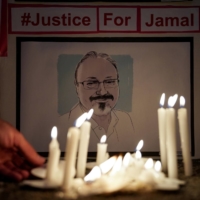 The Committee to Protect Journalists and other press freedom activists hold a candlelight vigil in front of the Saudi Embassy in Washington in October 2019 to mark the anniversary of the killing of journalist Jamal Khashoggi. | REUTERS 