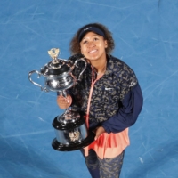 Naomi Osaka celebrates with the trophy after winning the Australian Open in Melbourne, Australia, on Feb. 20. | REUTERS