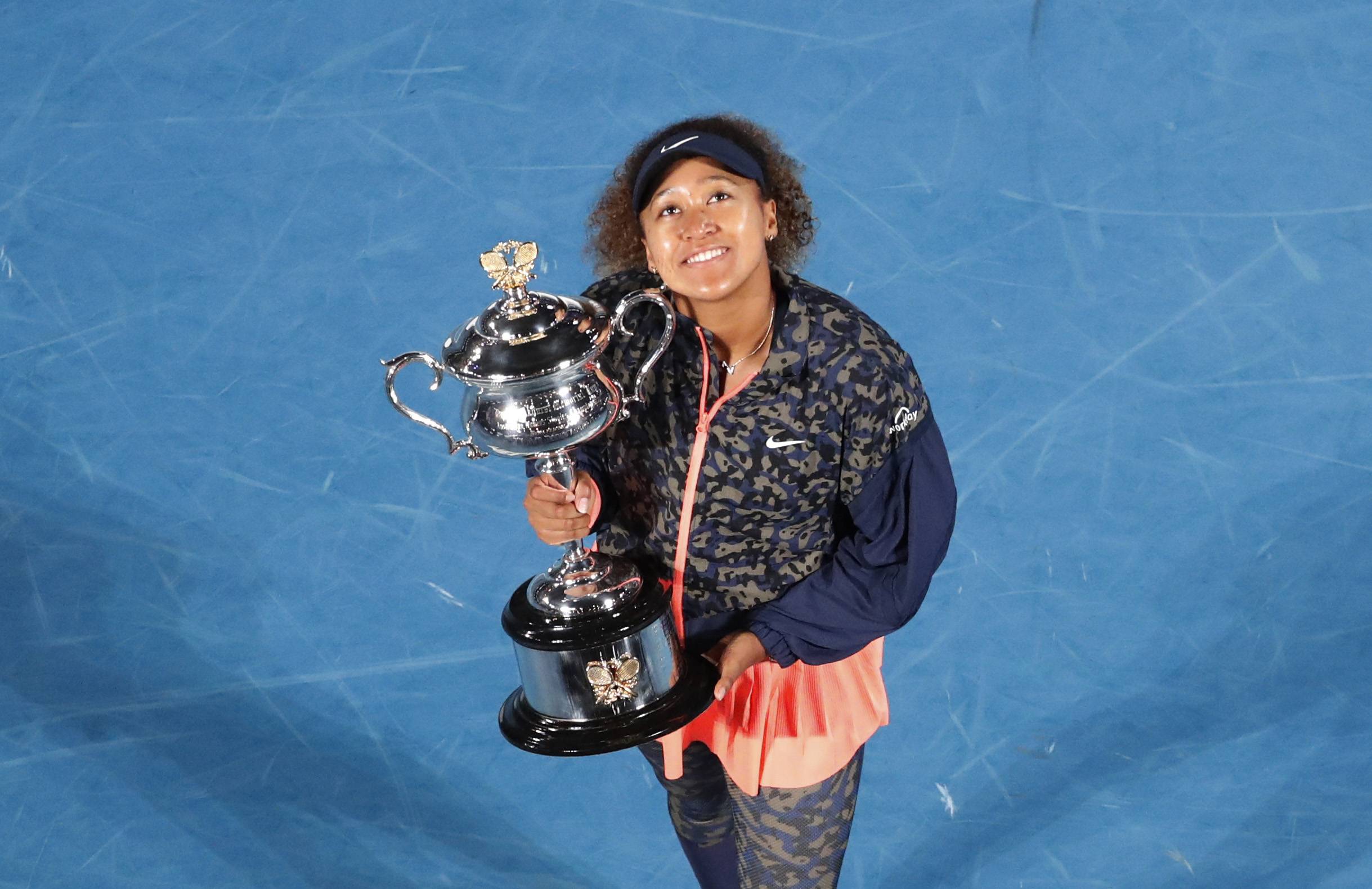 Naomi Osaka celebrates with the trophy after winning the Australian Open in Melbourne, Australia, on Feb. 20. | REUTERS