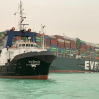 A handout picture released by the Suez Canal Authority on March 24, 2021 shows the MV Ever Given, operated by Taiwanese firm Evergreen, grounded in the Suez Canal, Egypt. | SUEZ CANAL / AFP-JIJI