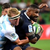 The Rebels\' Marika Koroibete (right) is tackled by the Waratahs\' Hugh Sinclair during a Super Rugby Australia match in Melbourne on March 19. | AFP-JIJI
