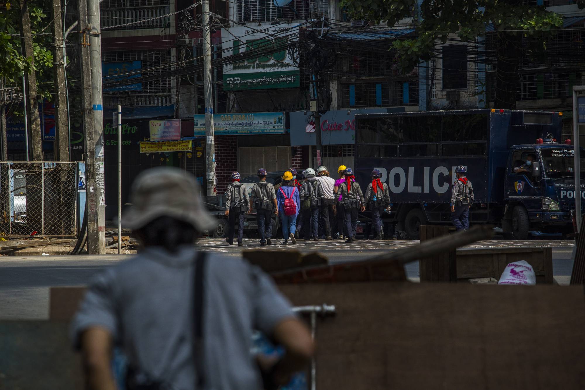 Police take arrested protesters to a prison truck in Yangon, Myanmar, on March 3. | THE NEW YORK TIMES