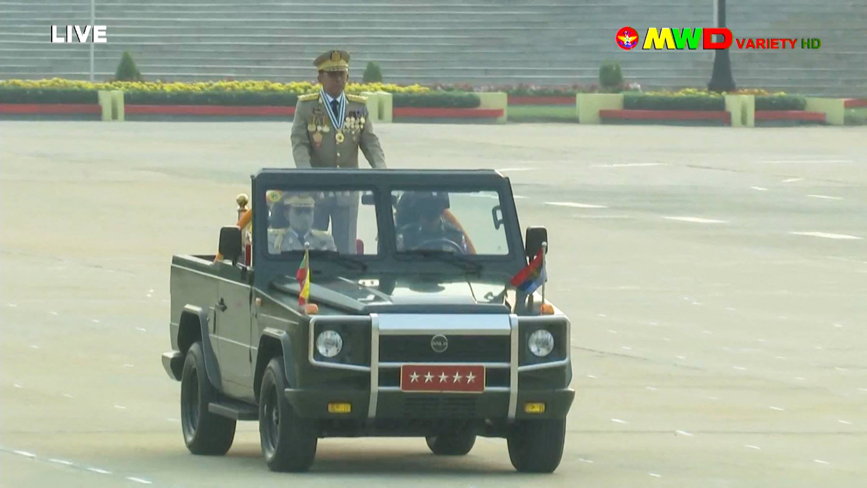 Myanmar armed forces chief Senior Gen. Min Aung Hlaing rides in car during an annual parade put on by the military to mark Armed Forced Day in the capital, Naypyidaw, in a screenshot taken from Myawaddy TV on Saturday. | Myawaddy TV / VIA AFP-JIJI