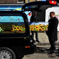 Pallbearers in Sheerness carry the coffin of a person who died after contracting the coronavirus, on the Isle of Sheppey, England, on March 19.  | REUTERS