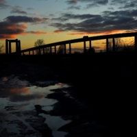 The sun sets on Kingsferry Bridge as seen from Sheerness, on the Isle of Sheppey, England.  | REUTERS