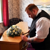 Funeral director Bobby Palliser prepares a coffin in Sheerness.  | REUTERS