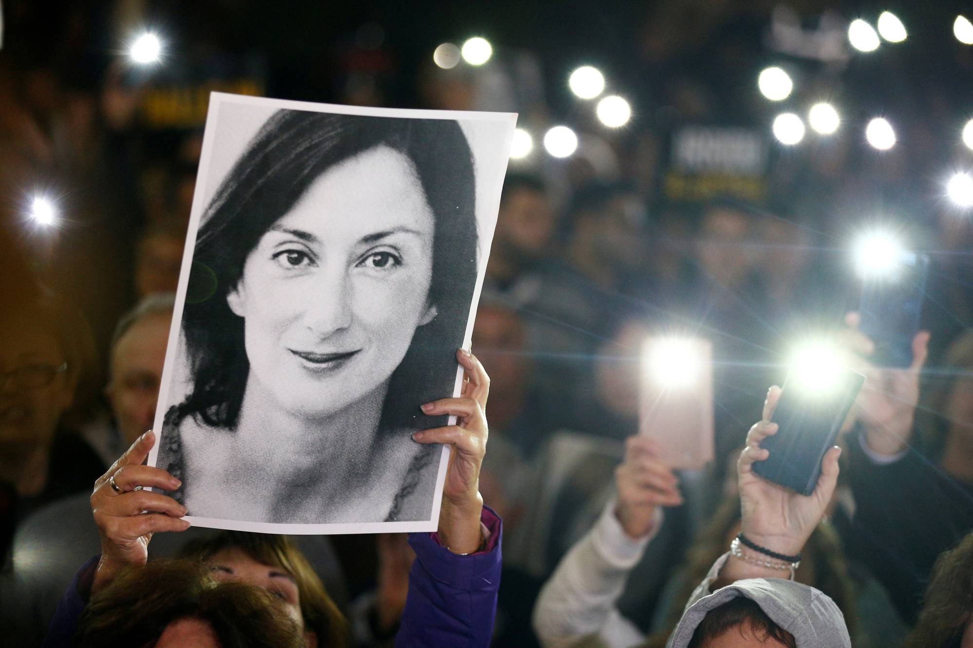 People gather at the Great Siege Square in Valletta, Malta, in November 2019 to call for the resignation of Joseph Muscat following the arrest of one of the country's most prominent businessmen as part of an investigation into the murder of journalist Daphne Caruana Galizia. | REUTERS 