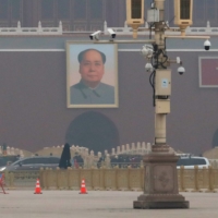 Surveillance cameras monitor the area in front of a portrait of the late Chinese chairman Mao Zedong on Tiananmen Gate in Beijing. | REUTERS 