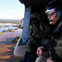 Australian Prime Minister Scott Morrison inspects flood damage from an Australian Army helicopter during a visit to affected areas in and around Sydney on March 24. | POOL / VIA AFP-JIJI