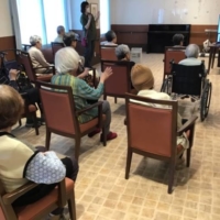 With many recreational activities canceled during the pandemic, nursing care provider Sompo Care Inc., hosts daily events streamed live on large television screens installed in its nursing facilities. | COURTESY OF SOMPO CARE INC.
