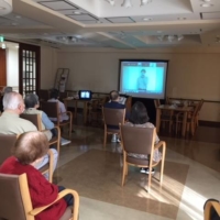 With many recreational activities canceled during the pandemic, nursing care provider Sompo Care Inc., hosts daily events streamed live on large television screens installed in its nursing facilities. | COURTESY OF SOMPO CARE INC.