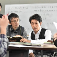 A story with bite: While making “Kiba: The Fangs of Fiction,” Daihachi Yoshida (seated, left) had a clear vision for the film’s charismatic but cutthroat protagonist, played by Yo Oizumi (center). | © 2021 “KIBA: THE FANGS OF FICTION\" FILM PARTNERS
