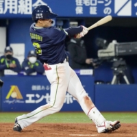 The Swallows\' Yasutaka Shiomi drives in a run against the BayStars during the fifth inning on Wednesday in Yokohama. | KYODO