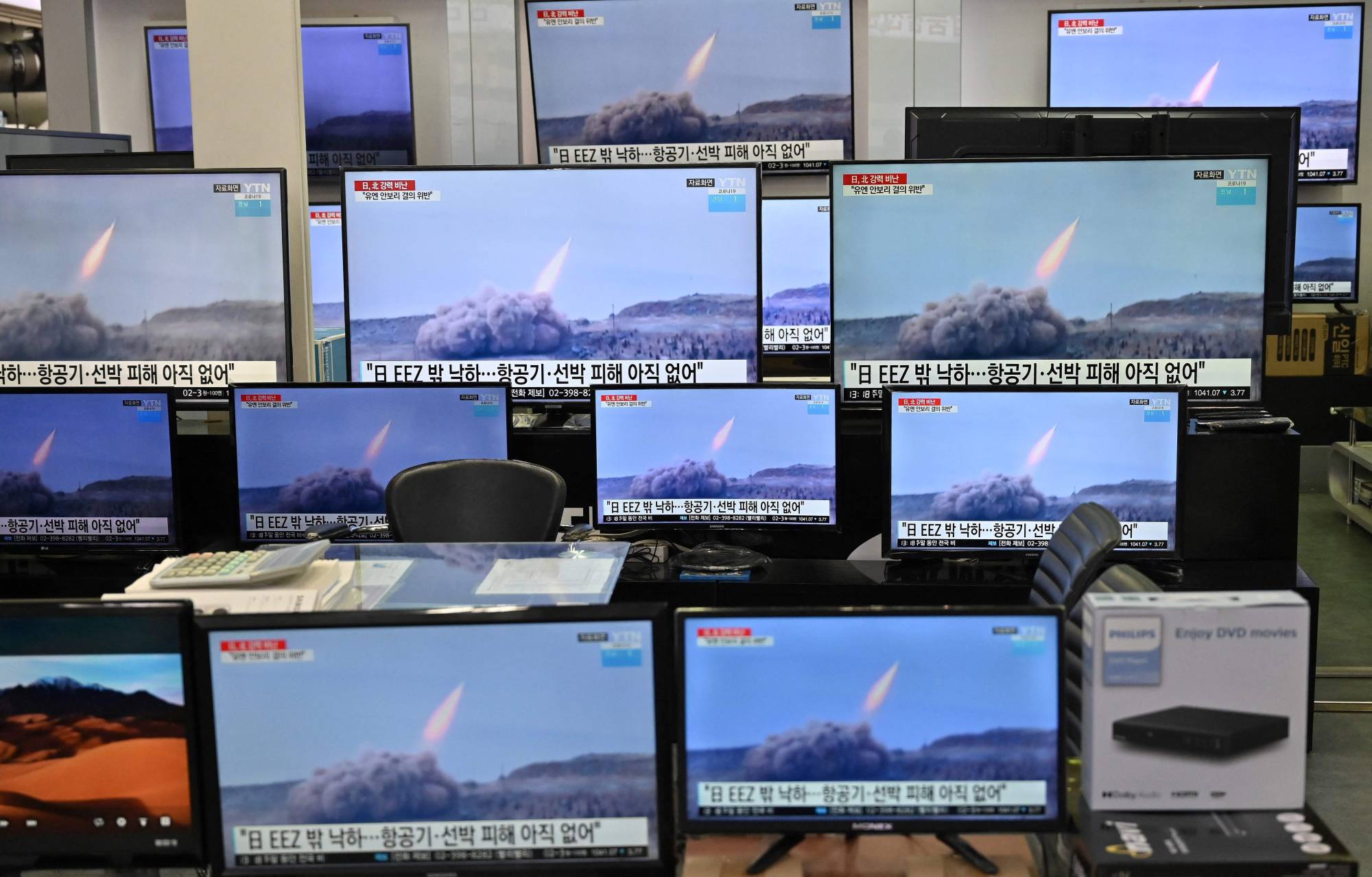 TV screens show file footage of a North Korean missile test, at an electronics store in Seoul on March 25. | AFP-JIJI