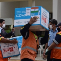 Workers unload boxes containing 100,000 doses of the Covaxin COVID-19 vaccine donated by India, in Luque, Paraguay.  | AFP-JIJI