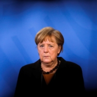German Chancellor Angela Merkel briefs the media after a virtual meeting with federal state governors at the chancellery in Berlin on March 30.  | POOL / VIA REUTERS