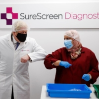 British Prime Minister Boris Johnson visits a diagnostics firm in February. Future historians may point to our encounter with COVID-19 to explain the inexplicable demise of handshakes and the rise of elbow-bumping.   | REUTERS