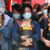 Relatives of victims grieve on Saturday at the accident site.  | REUTERS 