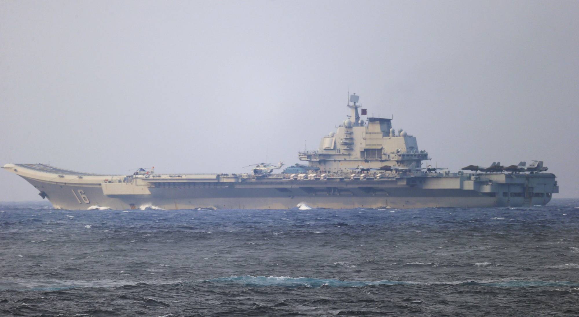 China's Liaoning aircraft carrier sails through the Miyako Strait near Okinawa over the weekend. | JAPAN DEFENSE MINISTRY / VIA KYODO