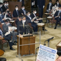 Prime Minister Yoshihide Suga speaks at an Upper House Audit Committee meeting on Monday. | KYODO