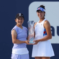 Shuko Aoyama (left) and Ena Shibahara pose with the Butch Bucholz Trophy after winning the women\'s doubles final at the Miami Open on Sunday. | USA TODAY / VIA REUTERS