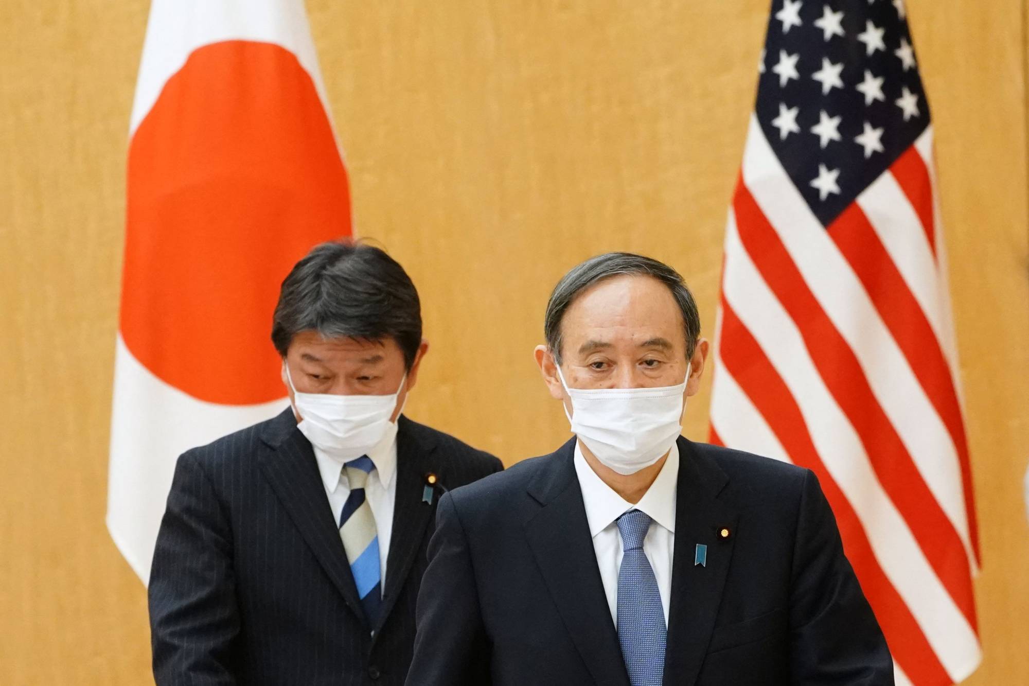 Prime Minister Yoshihide Suga and Foreign Minister Toshimitsu Motegi go to meet Antony Blinken, U.S. Secretary of State, and Lloyd Austin, U.S. Secretary of Defense, at the prime minister's official residence in Tokyo on March 16. | POOL / VIA AFP-JIJI