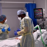 Nurses treat a COVID-19 patient in the intensive care unit at Milton Keynes University Hospital in Milton Keynes, U.K., on Jan. 20. | REUTERS