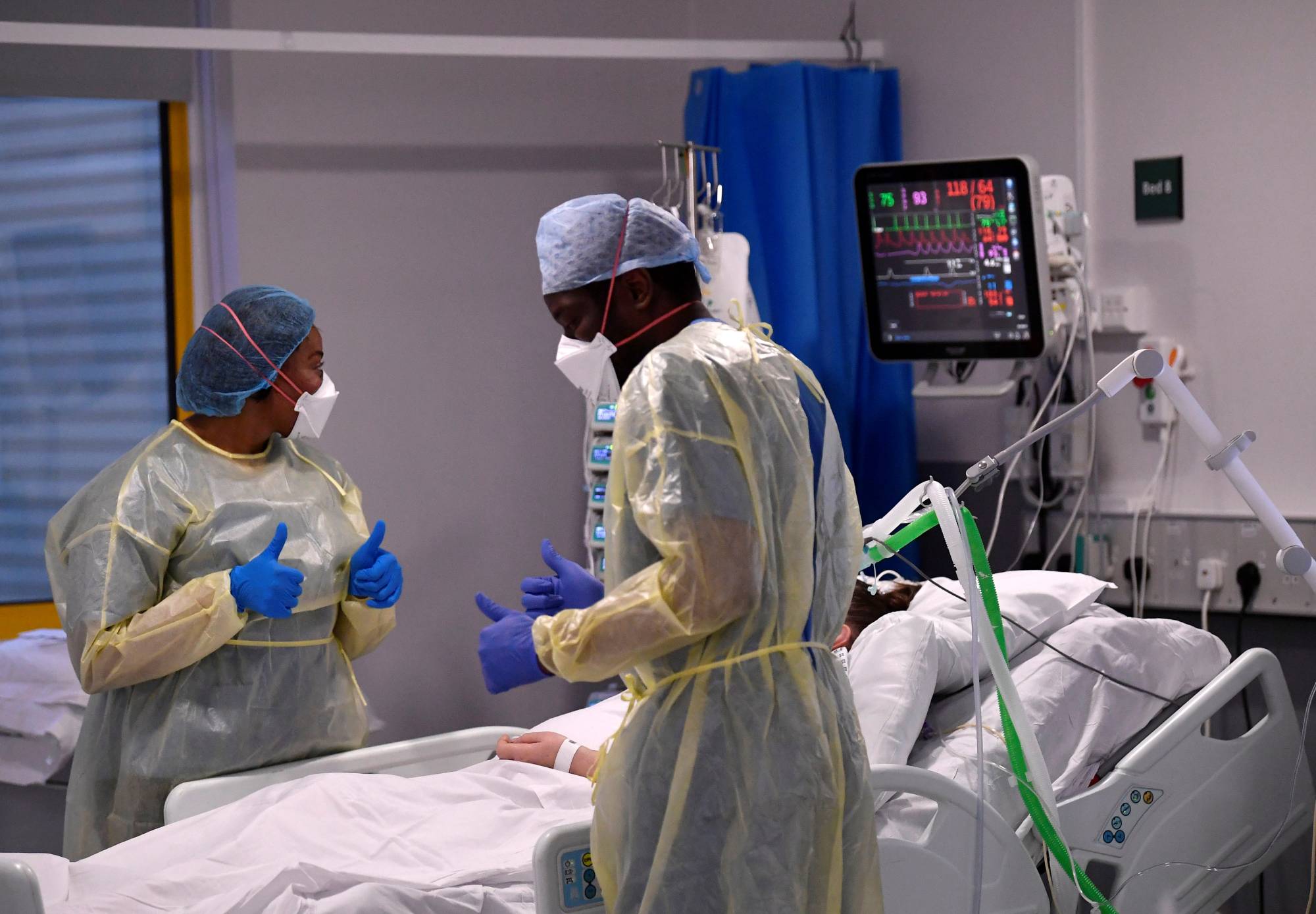 Nurses treat a COVID-19 patient in the intensive care unit at Milton Keynes University Hospital in Milton Keynes, U.K., on Jan. 20. | REUTERS