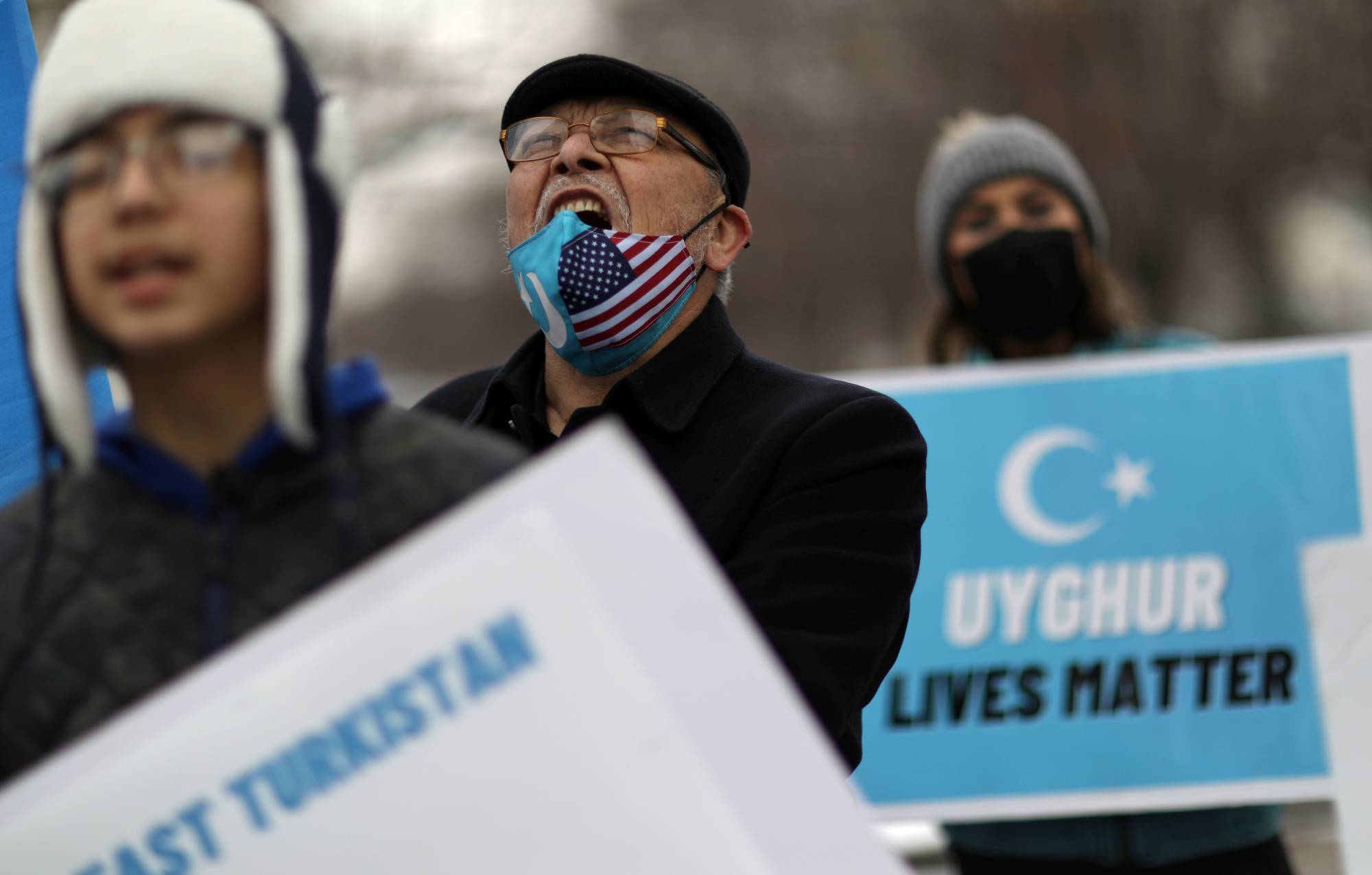 A man chants with others during a rally against China's treatment of its Uyghur population and Muslim minorities, in Washington in February. | REUTERS