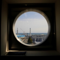 Storage tanks for treated water are seen through a window at the tsunami-crippled Fukushima No. 1 nuclear power plant in Fukushima Prefecture in March. | REUTERS