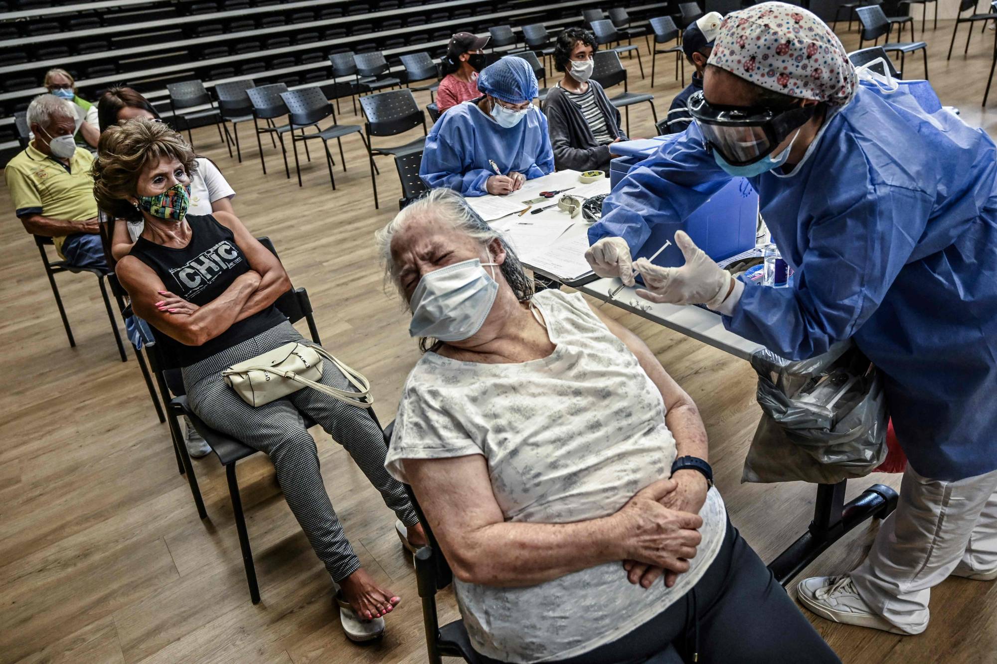 A woman is inoculated with the AstraZeneca COVID-19 vaccine in Medellin, Colombia, on Wednesday.  | AFP-JIJI