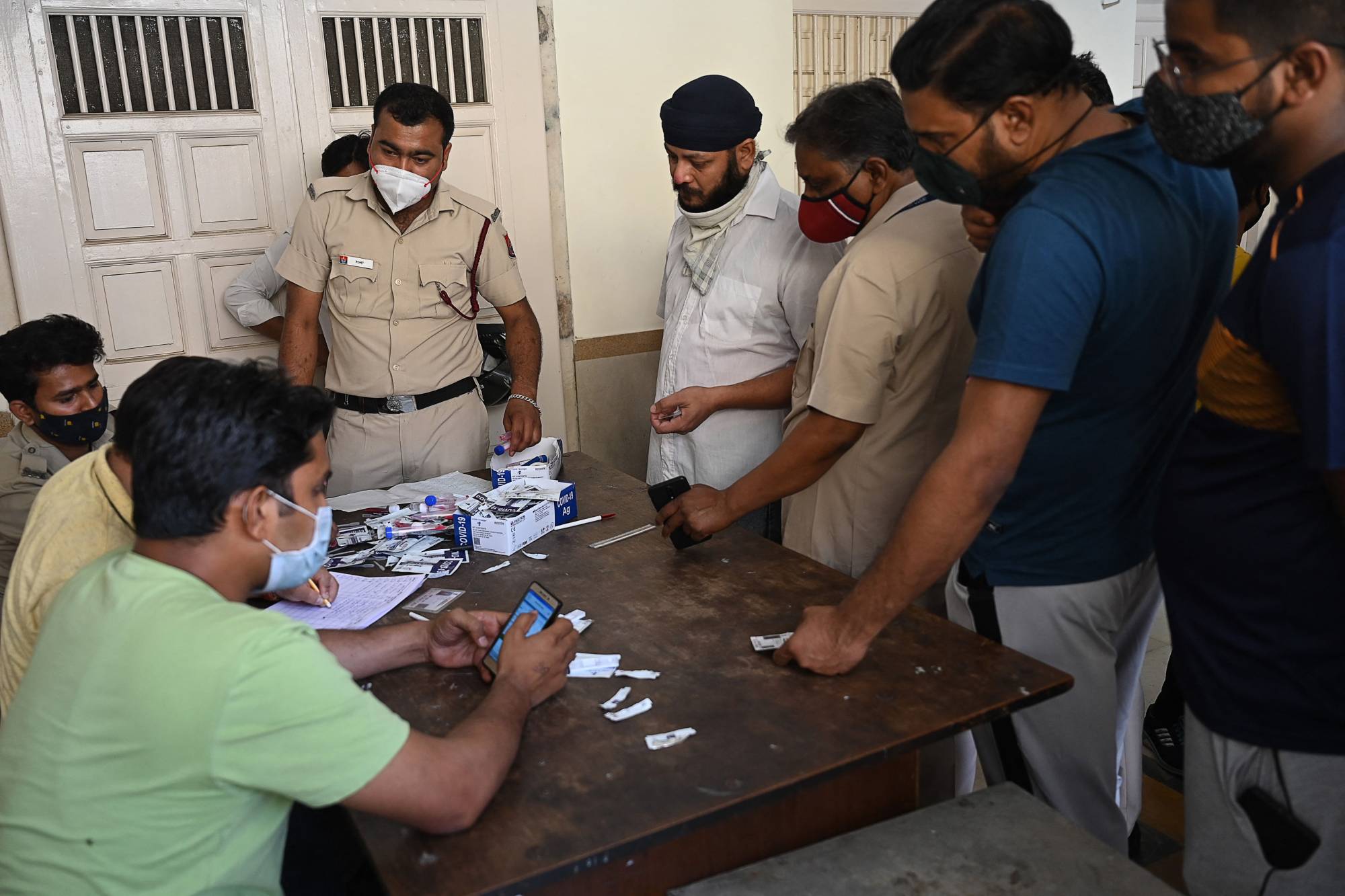 People wait to get an antigen test at a temporary center at a temple in New Delhi on Thursday. | AFP-JIJI