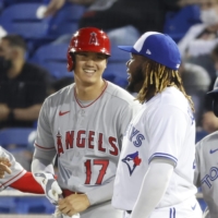 The Angels\' Shohei Ohtani talks with Blue Jays first basemen Vladimir Guerrero Jr. after a single during the seventh inning of their game on Thursday. | USA TODAY / VIA REUTERS