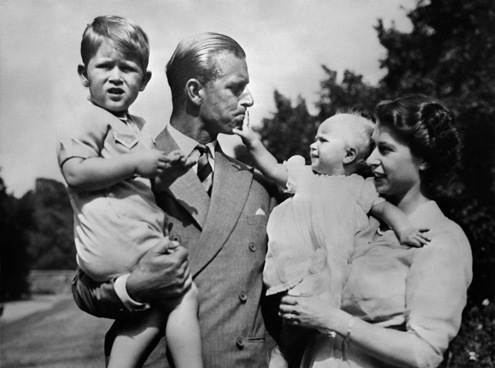 The Royal British couple — Queen Elizabeth II, and her husband, Prince Philip, Duke of Edinburgh — with their two children, Charles, Prince of Wales, and Princess Anne, in 1952. | VIA AFP-JIJI