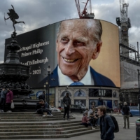 A photo of Prince Philip dominates Picadilly Circus in London on Friday, after his death was announced earlier in the day. | ANDREW TESTA / THE NEW YORK TIMES
