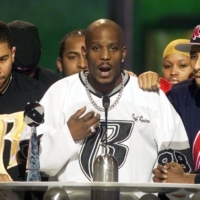 Rapper DMX (center) offers a prayer after winning the R&B Albums Artist of the Year award at the Billboard Music Awards show at the MGM Grand Hotel in Las Vegas in December 1999. | REUTERS