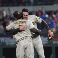 San Diego Padres starting pitcher Joe Musgrove (44) celebrates his no-hitter with center fielder Trent Grisham on Saturday in Arlington, Texas.  | USA TODAY SPORTS / VIA REUTERS