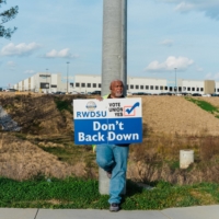 A member of the Wholesale and Department Store Union campaigns outside the Amazon warehouse in Bessemer, Alabama on March 12.  | BOB MILLER / THE NEW YORK TIMES