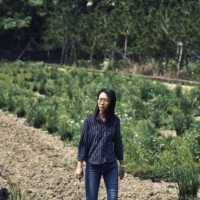 Kuo Yu-ling on a plot of parched land where she and her partner, Chuang Cheng-deng, normally grow rice and vegetables in Hsinchu, Taiwan. | AN RONG XU / THE NEW YORK TIMES