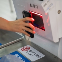 Signage for the digital yuan at a self check-out counter at a supermarket in Shenzhen, China | BLOOMBERG 