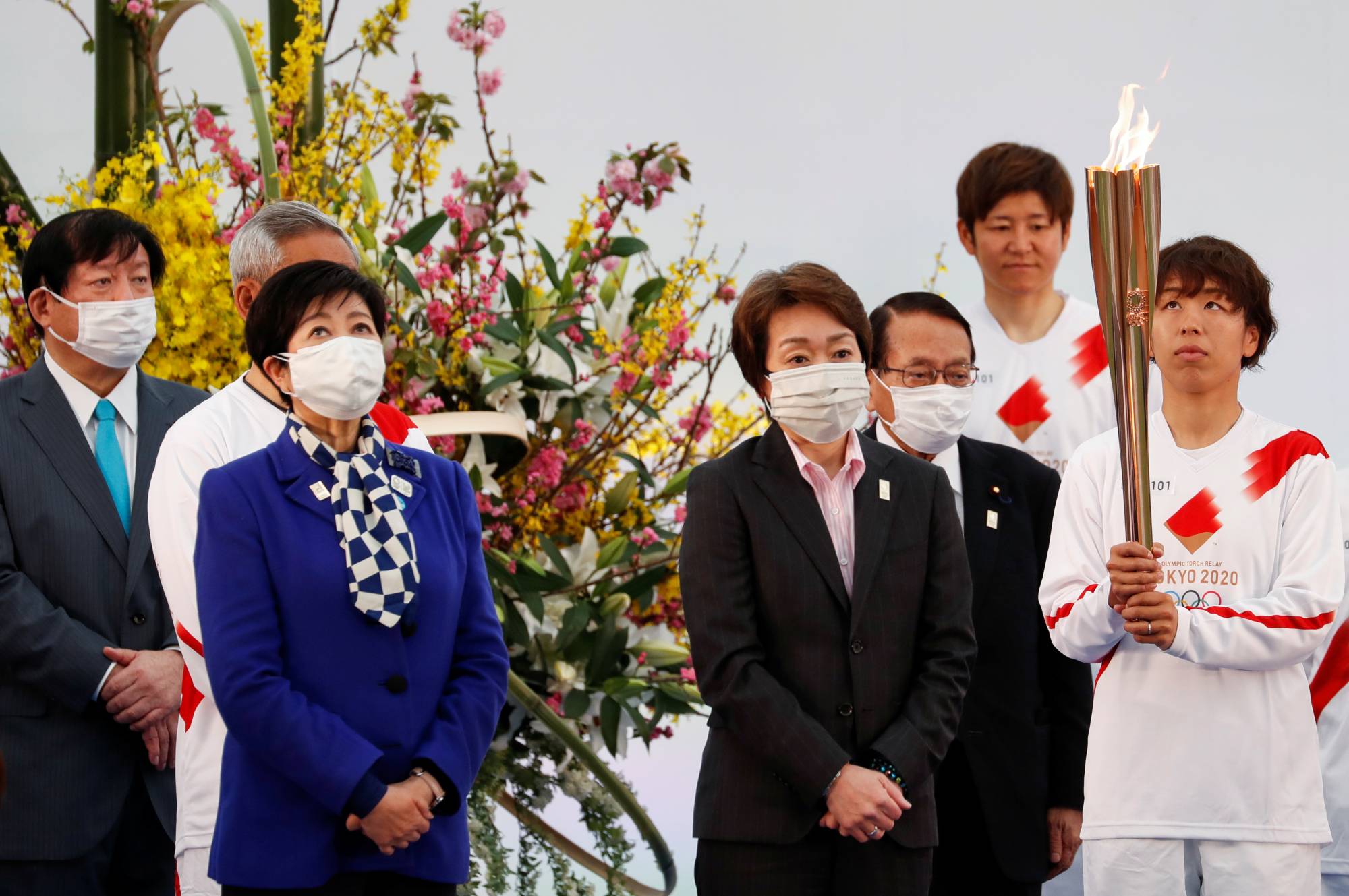 Tokyo 2020 President Seiko Hashimoto (second from right) attends the start of the Olympic torch relay in Naraha, Fukushima Prefecture, on March 25. | REUTERS